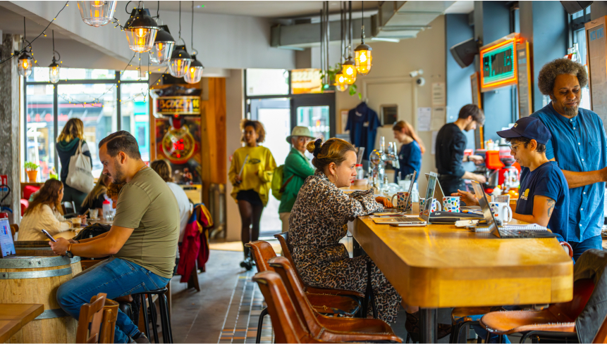 photo du bar avec des clients qui boivent, mangent et travaillent